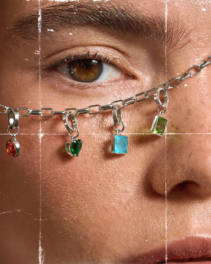 Gemstone jewellery draped across a face