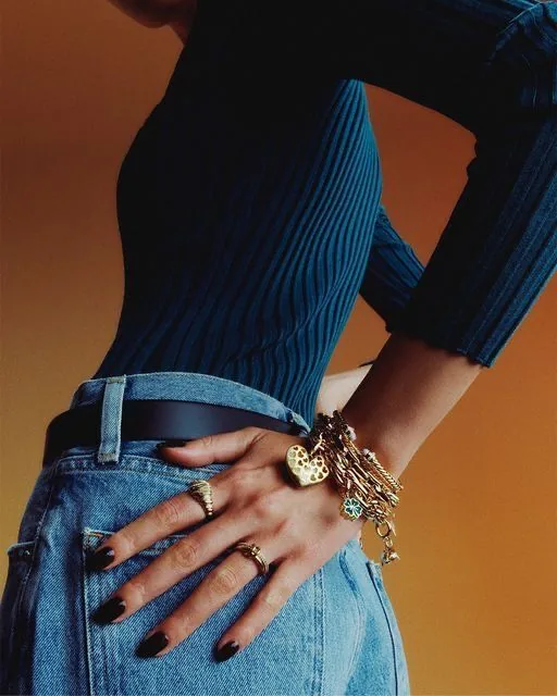 Editorial image of jewellery styled with blue knitwear